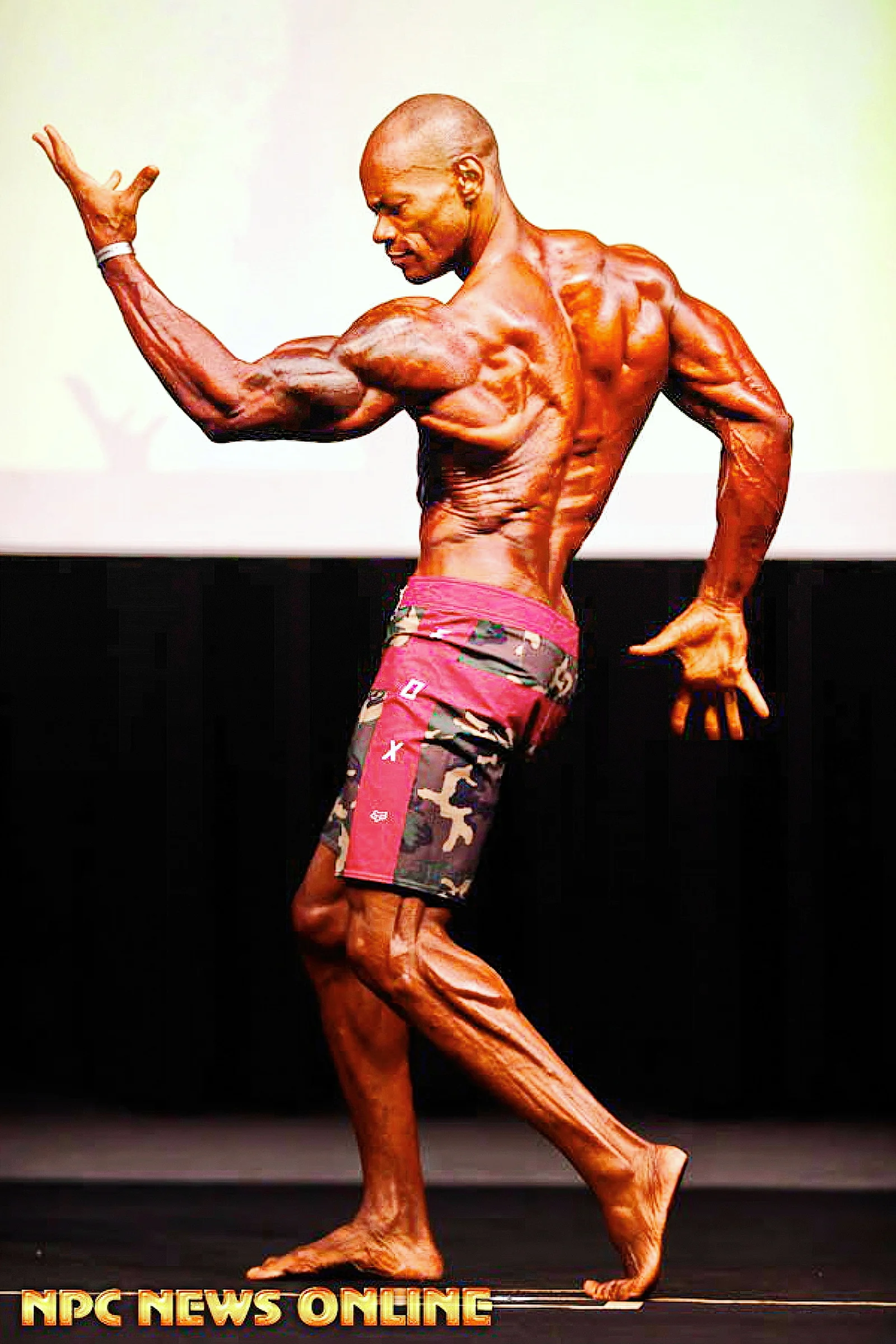 Antony Bessala back pose on stage.